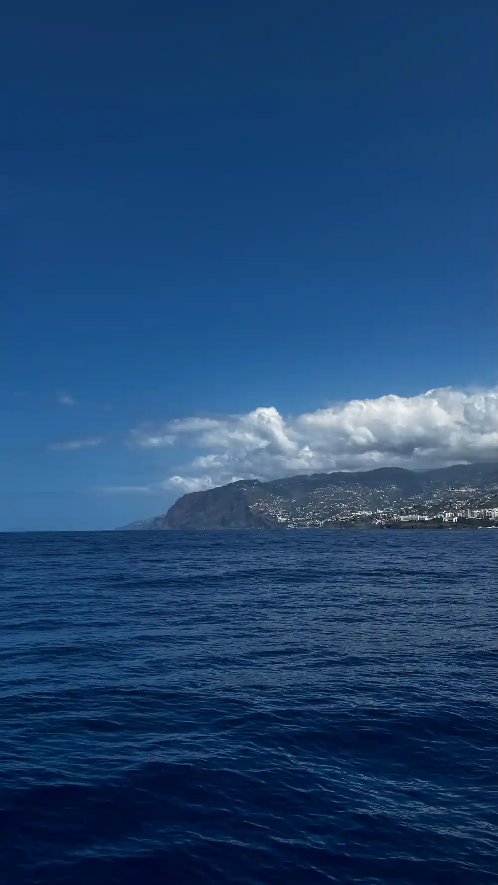 Cloud over the island seen from open water