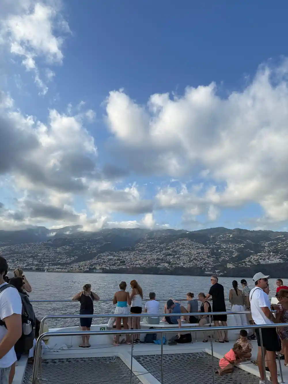 Guests at the rail with Funchal on the hillside behind