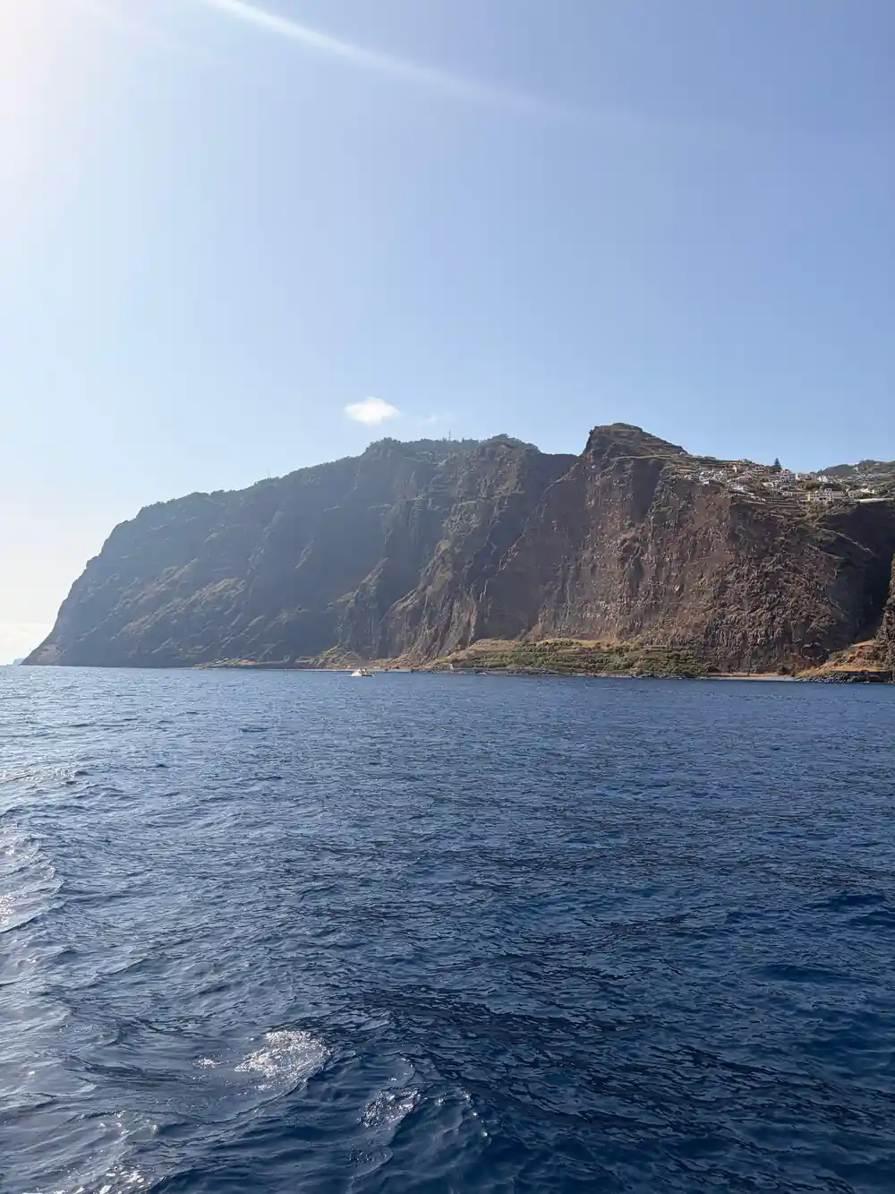 A tall red rock headland rising from the sea